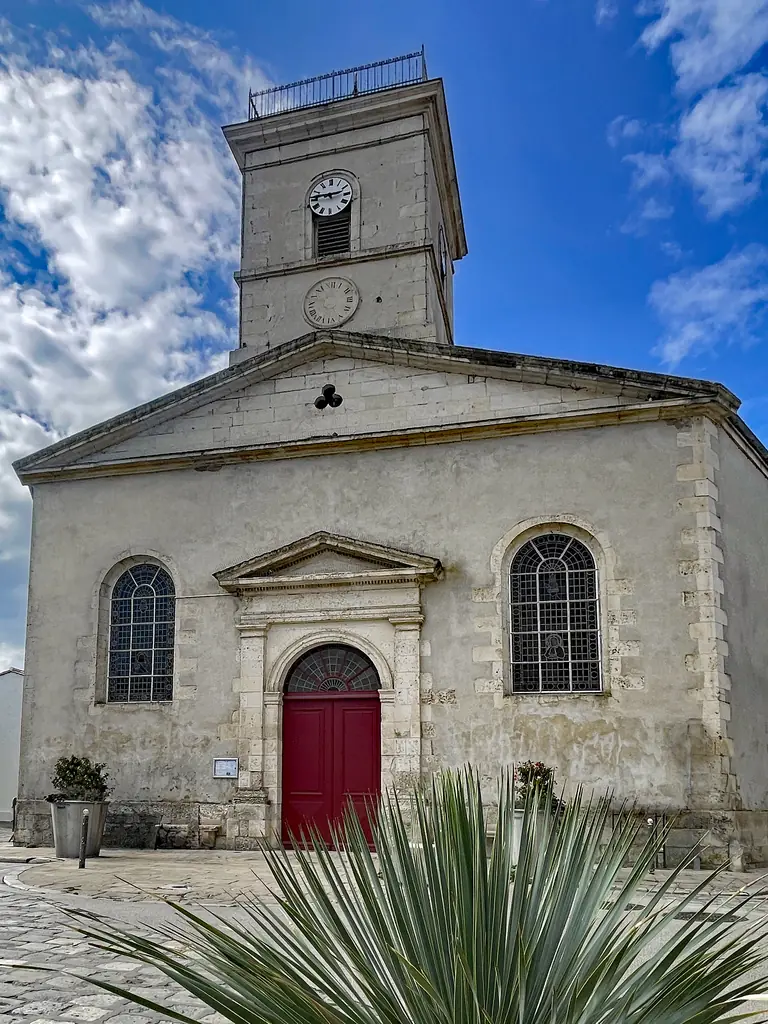 The bell tower and red door of All Saints’ church (1832) in Le Bois-Plage-en-Ré