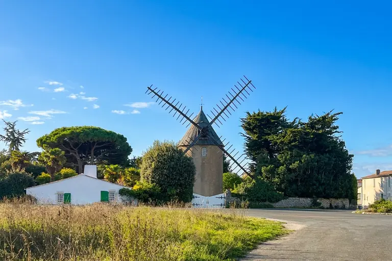 The windmill of Le Bois-Plage-en-Ré and a traditional Ré house with green shutters