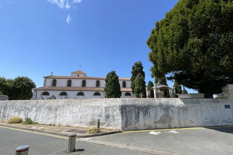 Loix church behind its white wall