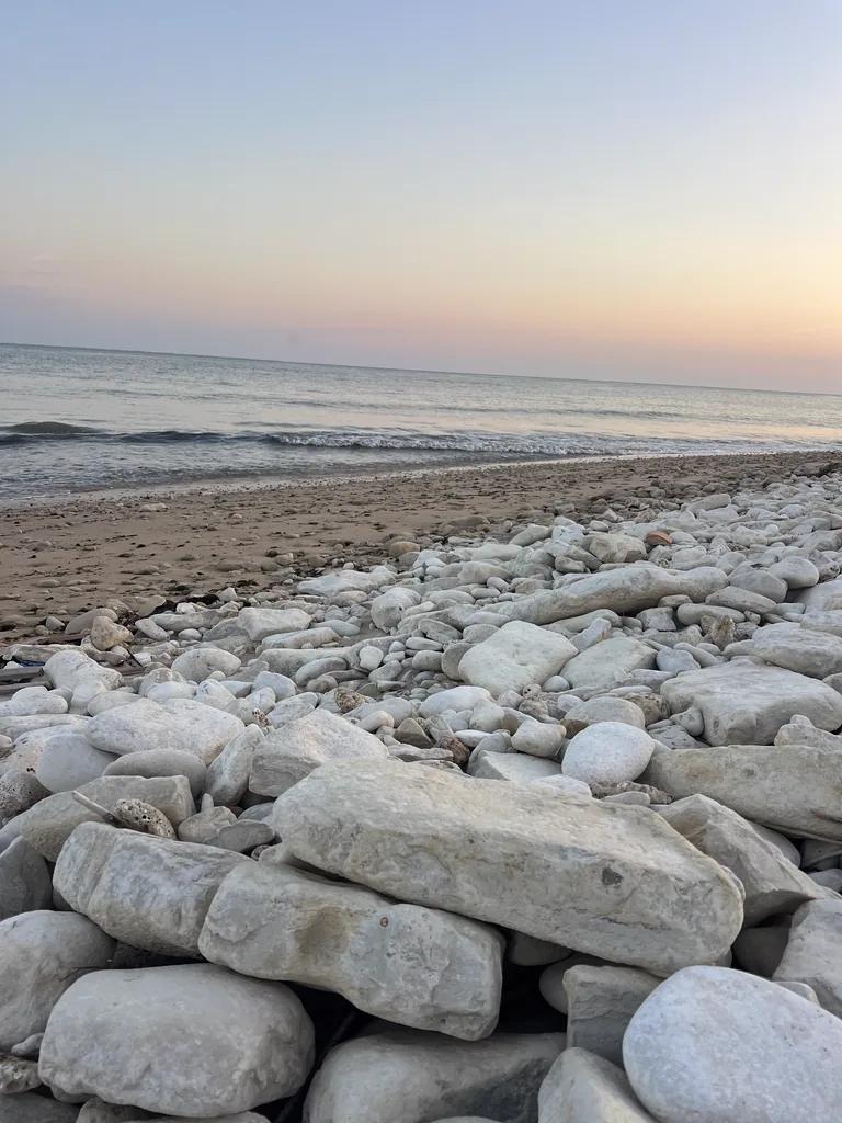 Pebbles on the beach of Sainte-Marie-de-Ré at sunset